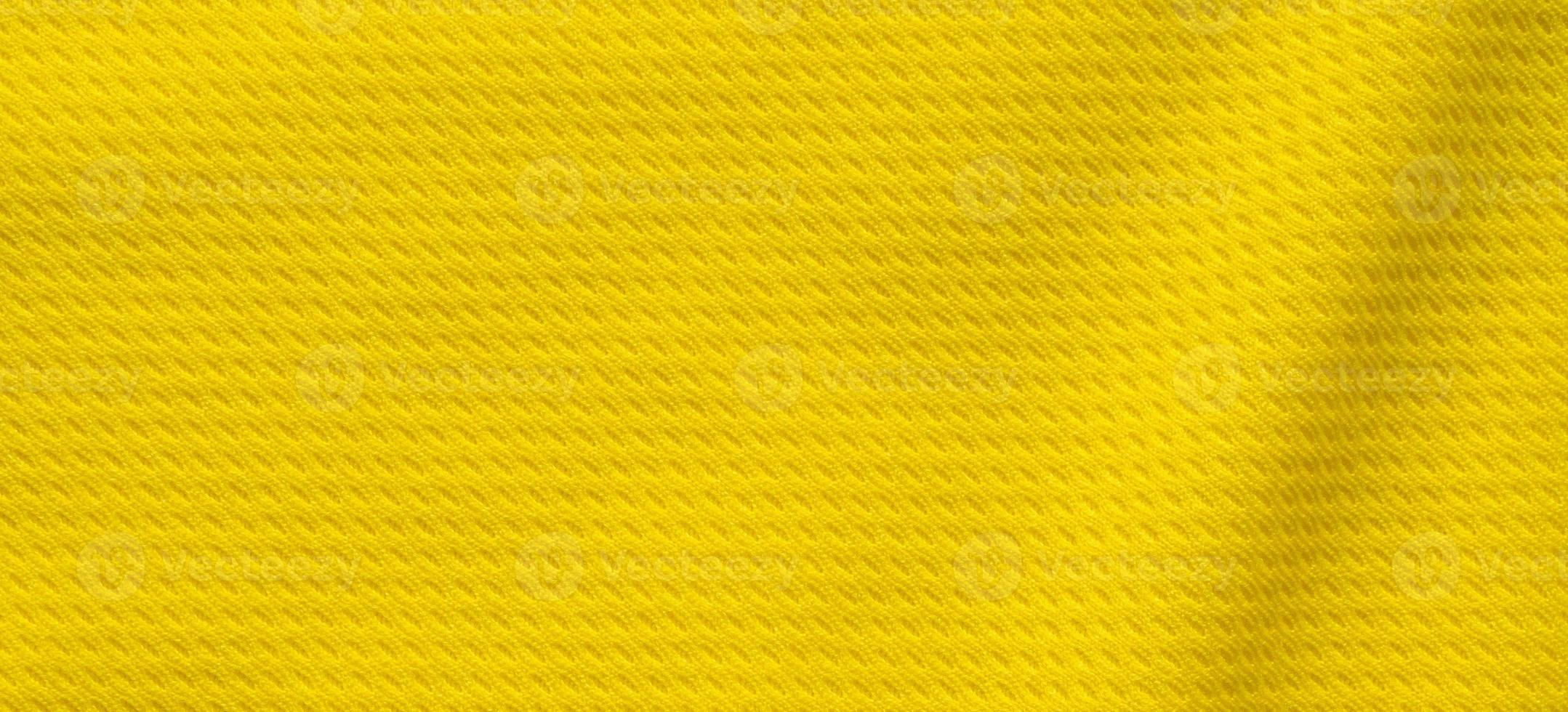 Yellow sports clothing fabric football shirt jersey texture close up photo