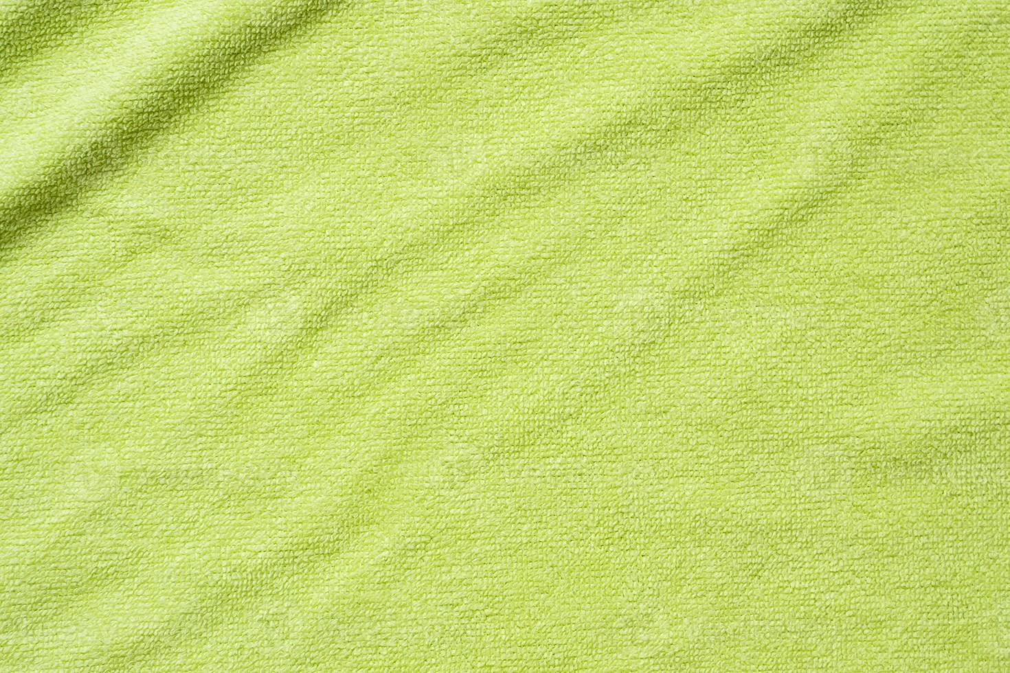 Green towel fabric texture surface close up background photo