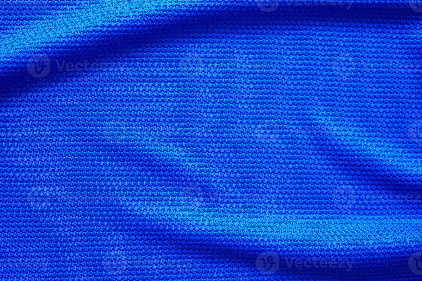 Blue football jersey clothing fabric texture sports wear background, close up top view photo