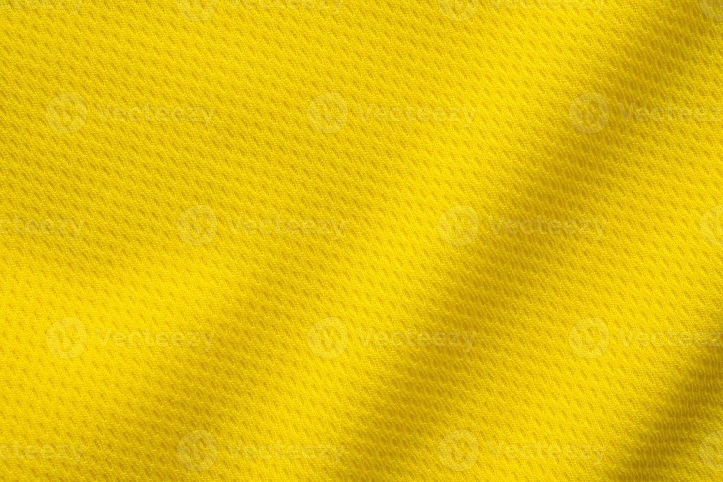 Yellow sports clothing fabric football shirt jersey texture close up photo