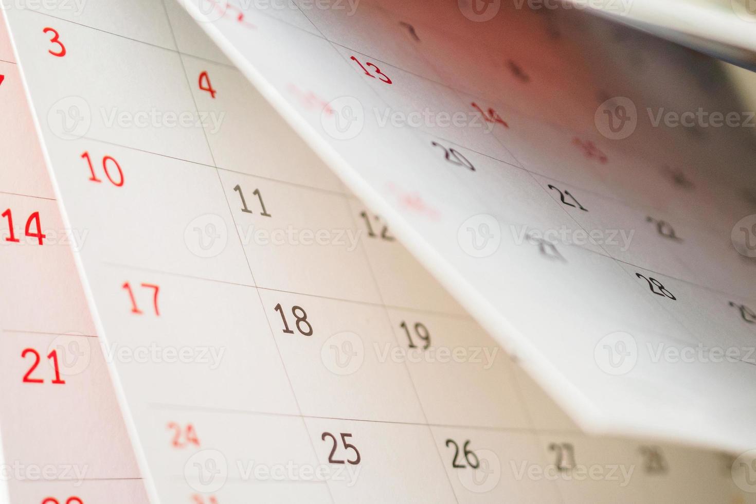 Calendar page flipping sheet close up on office table background business schedule planning appointment meeting concept photo