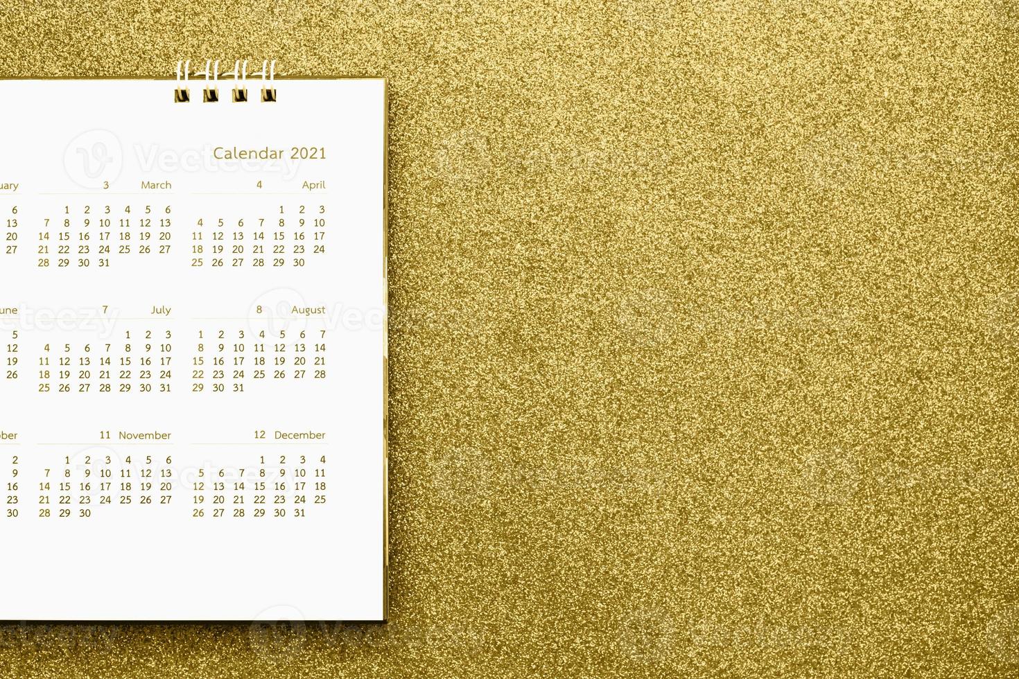 Happy new year 2021 calendar page close up on gold glitter sparkle background photo