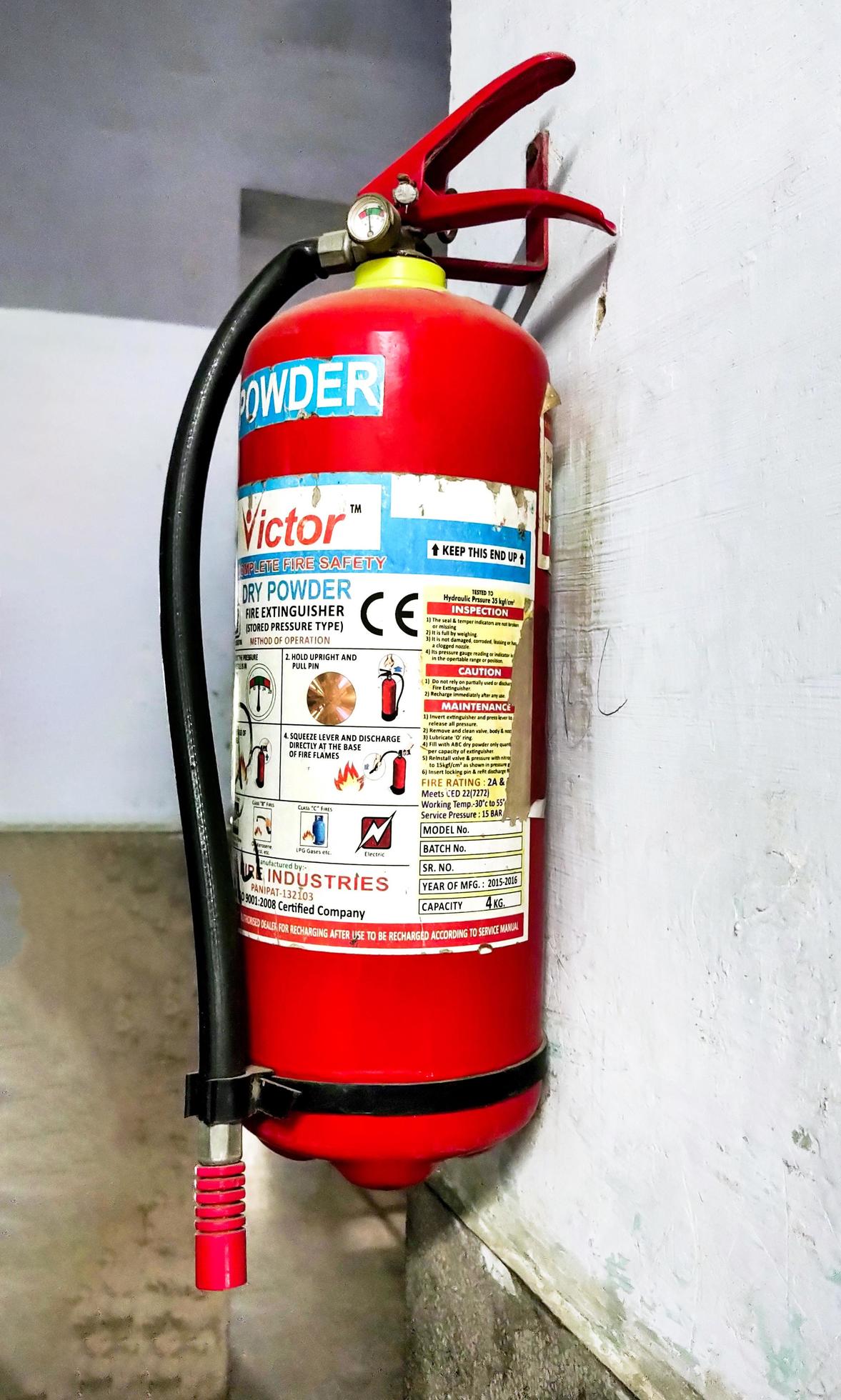 Hisar, Haryana august 2021, red fire extinguisher hanging on the wall