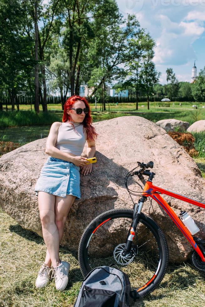 Young attractive woman is resting after bicycle ride. Active lifestyle, sports photo