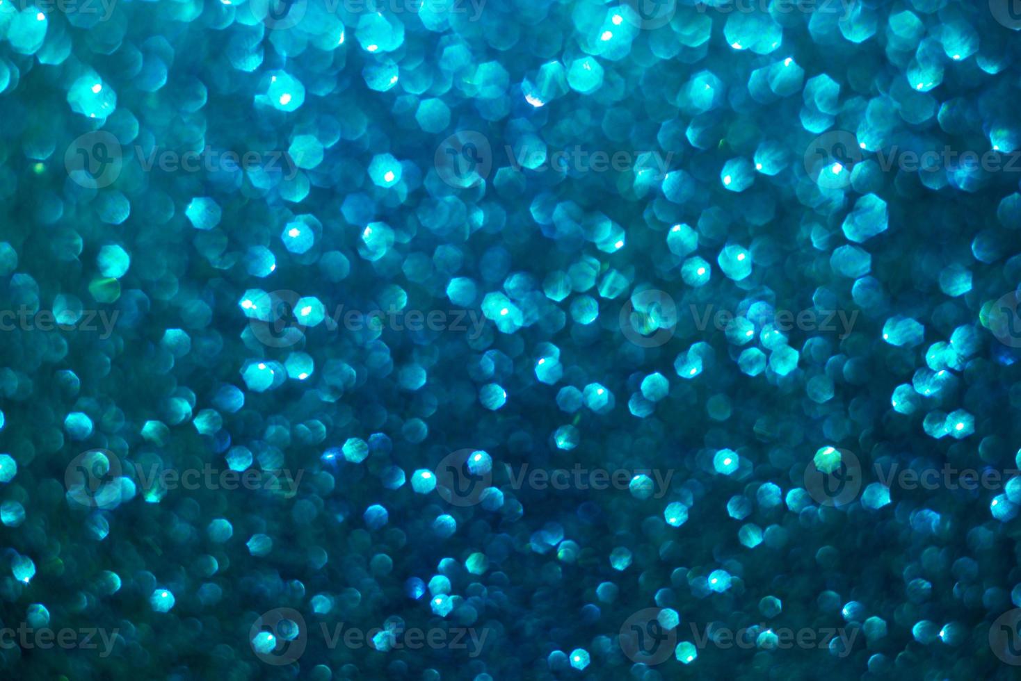 defocused abstract background glittering with bright blue sparkles photo