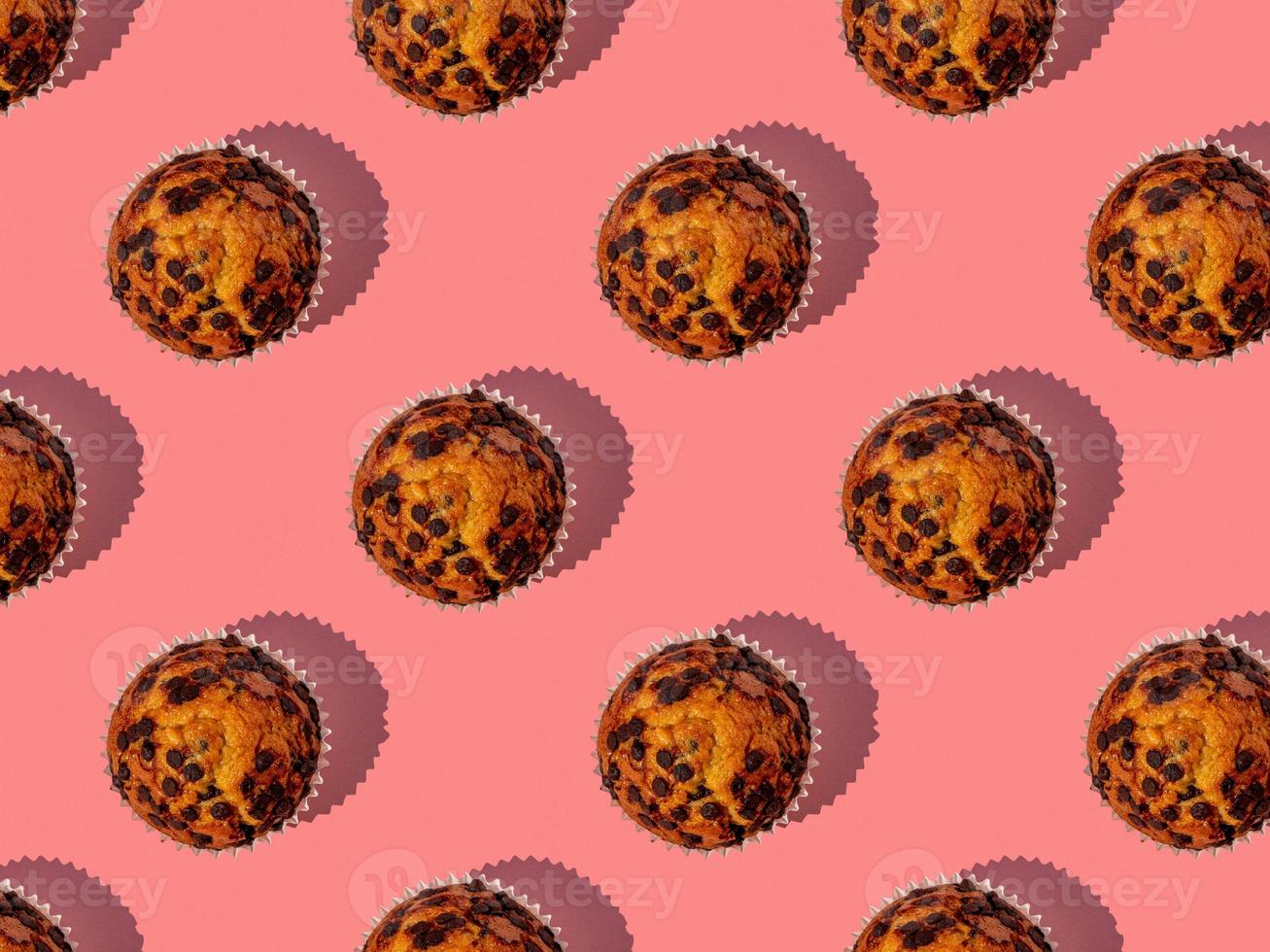 Seamless pattern of a tasty chocolate chip muffin. photo