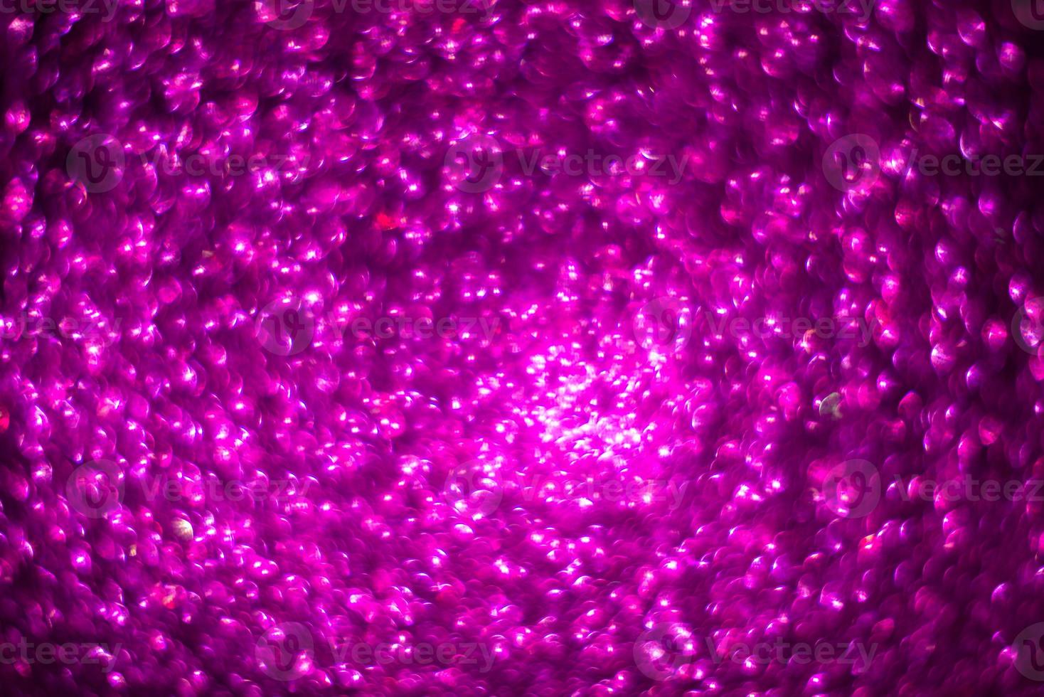 defocused abstract background glittering with bright lilac sparkles. photo