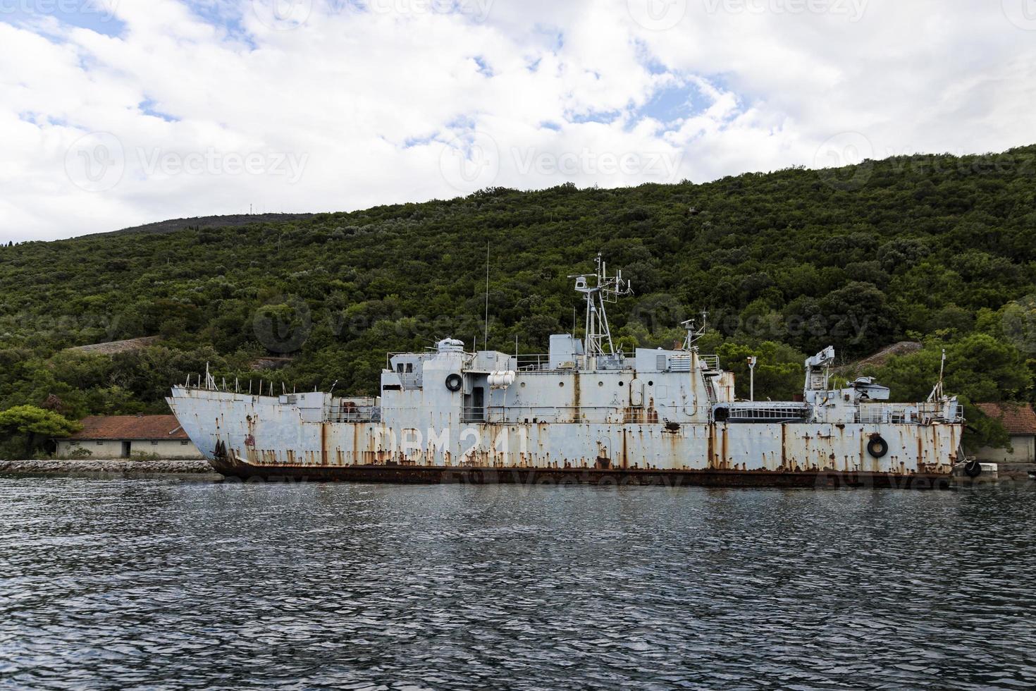 A rusty warship at the pier, off the coast of the Adriatic Sea. photo