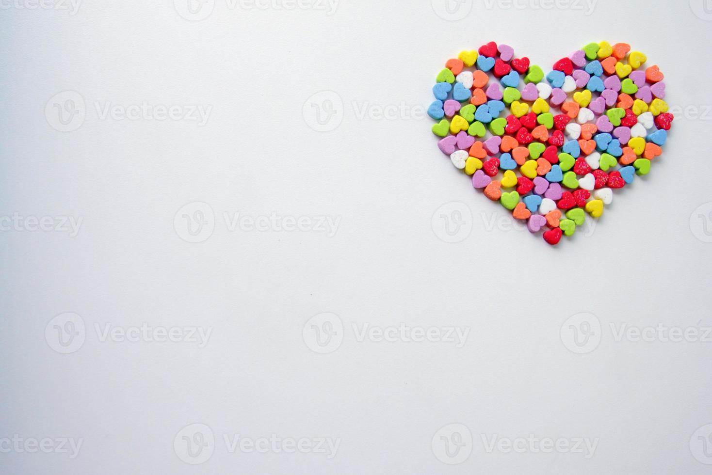 A lot of the little shining colorful hearts in one big heart for Valentine's Day. photo