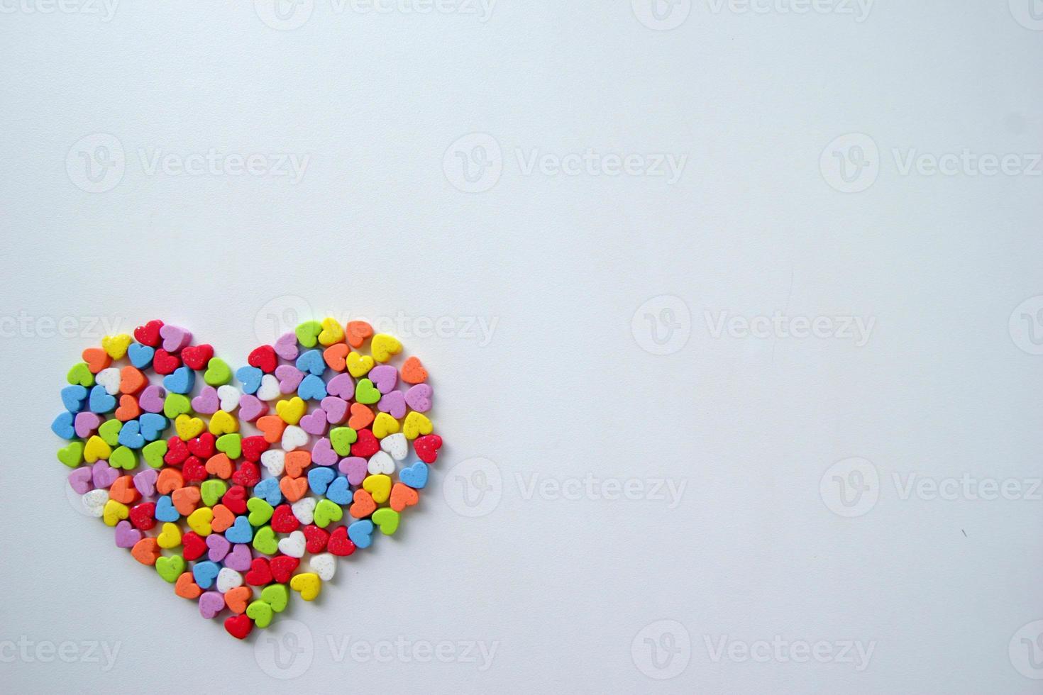 A lot of the little shining colorful hearts in one big heart for Valentine's Day. photo