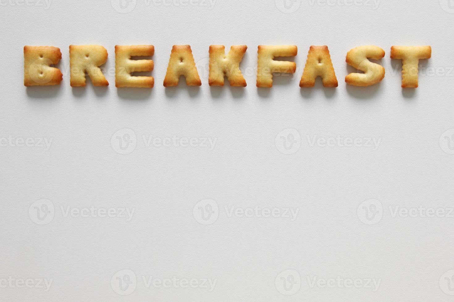 An inscription from the cookies on the white background. Text - breakfast. photo