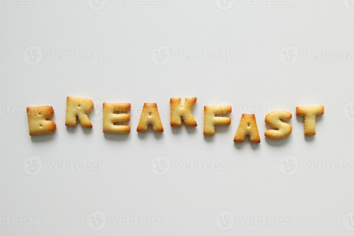 An inscription from the cookies on the white background. Text - breakfast. photo
