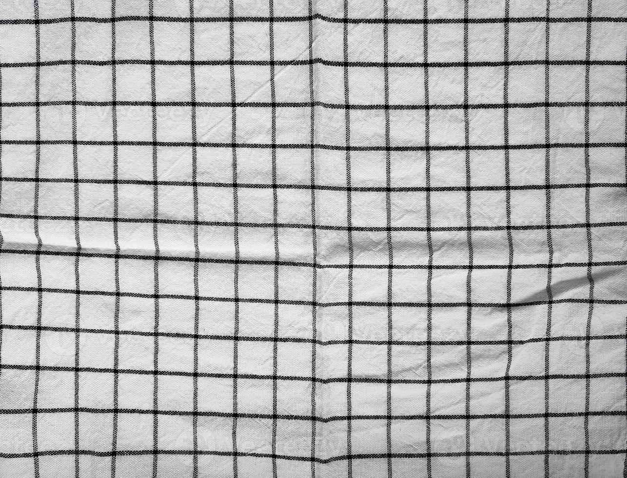 Checkered tablecloth fabric or towel. Black with white square pattern photo