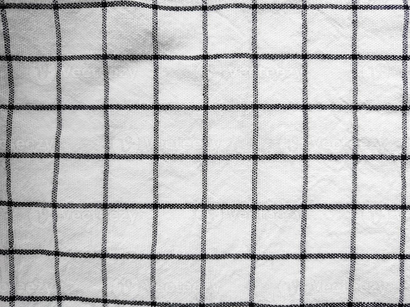 Checkered tablecloth fabric or towel. Black with white square pattern photo