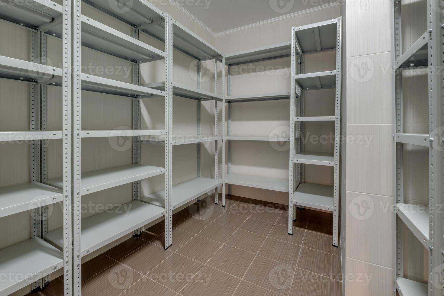 rows of metal shelves in fridge wardrobe. refrigerator for storing large amounts of food photo