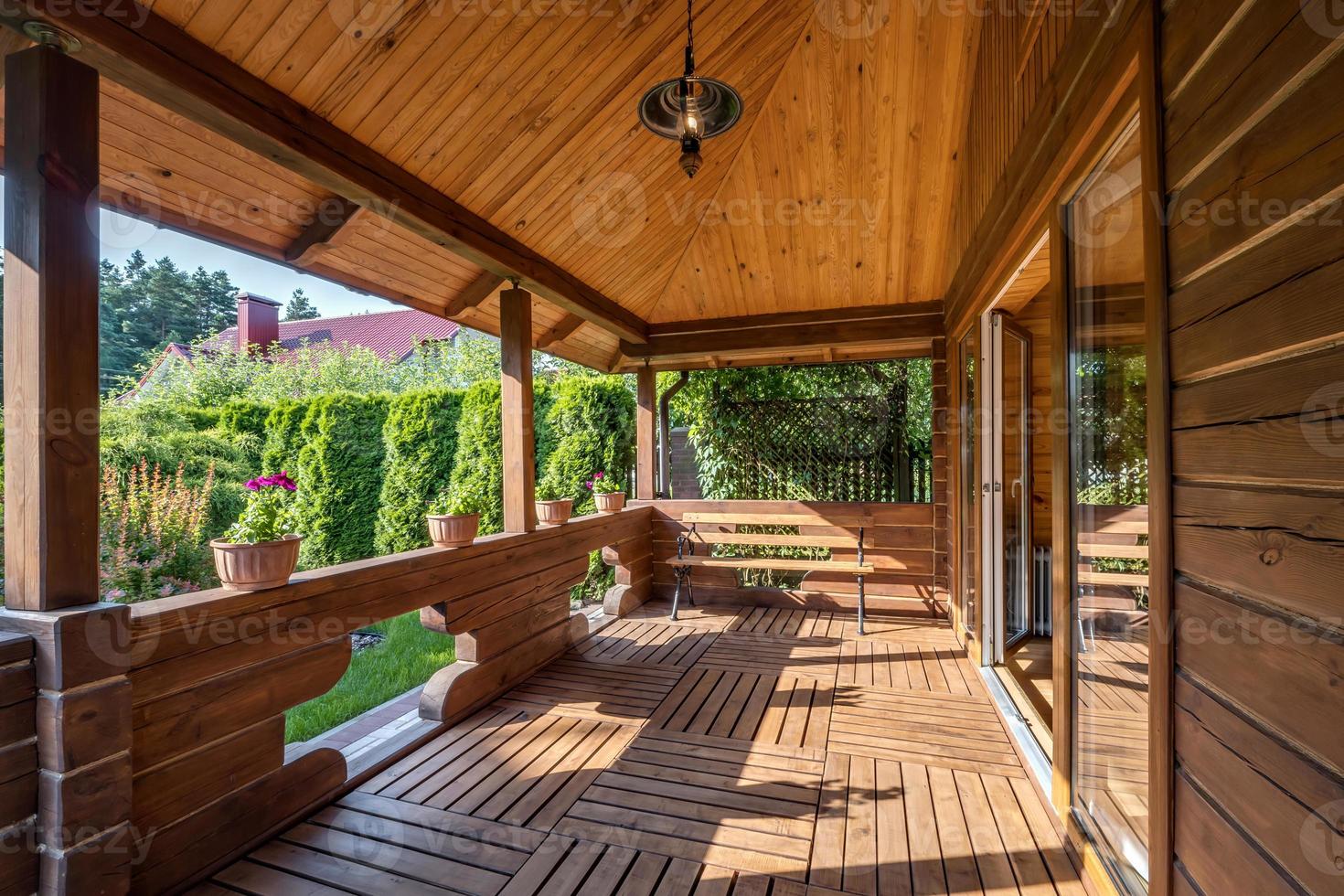 interior of empty hall veranda in wooden village vacation home with garden chairs photo