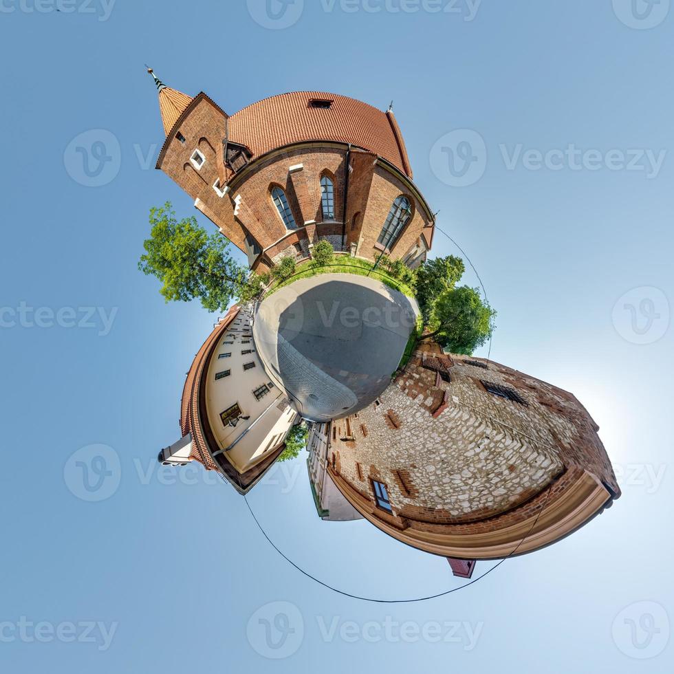 Little planet and spherical aerial 360 panorama view on street ancient medieval city with church and historic buildings photo