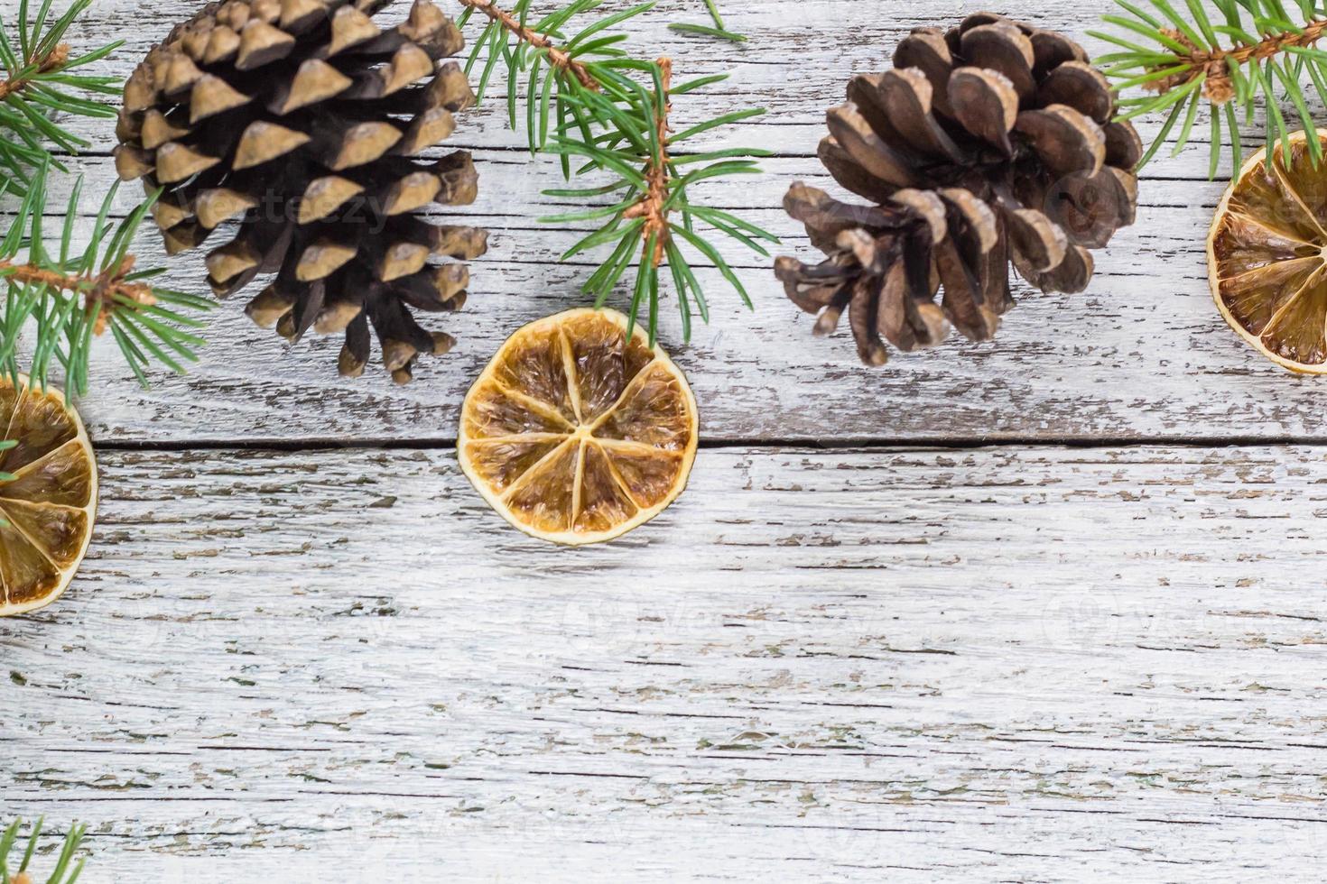 Christmas fir branches with cones and dry lemon slice photo