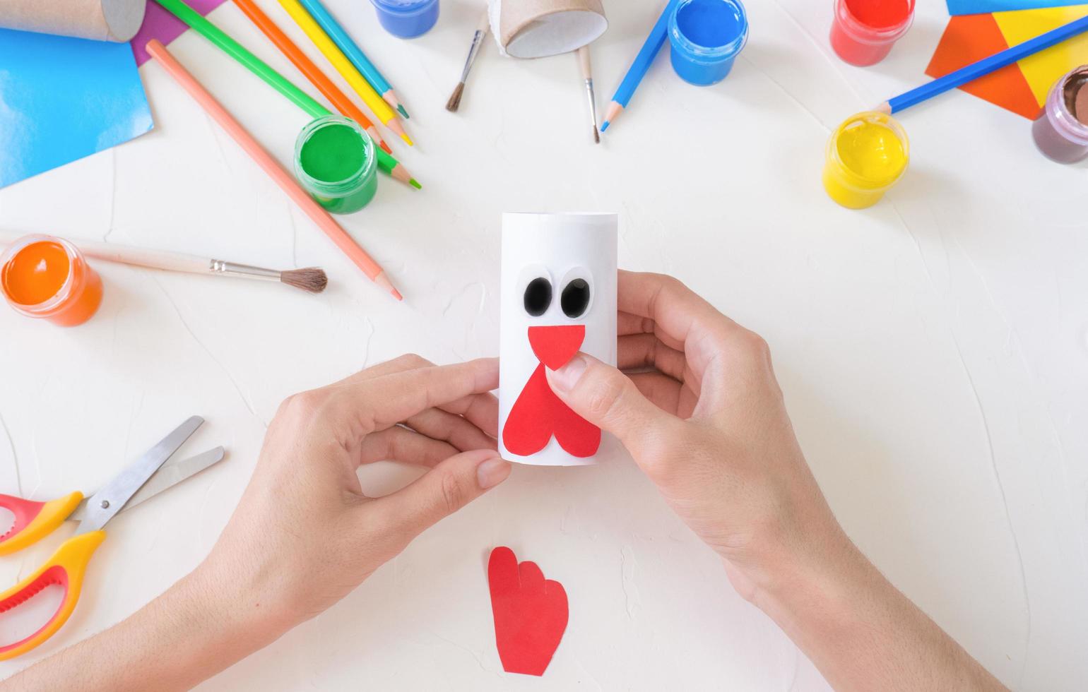 step3. The concept of decorating a kindergarten with easter - a chicken, a rooster from a roll of toilet paper. A simple creative idea with your own hands. photo