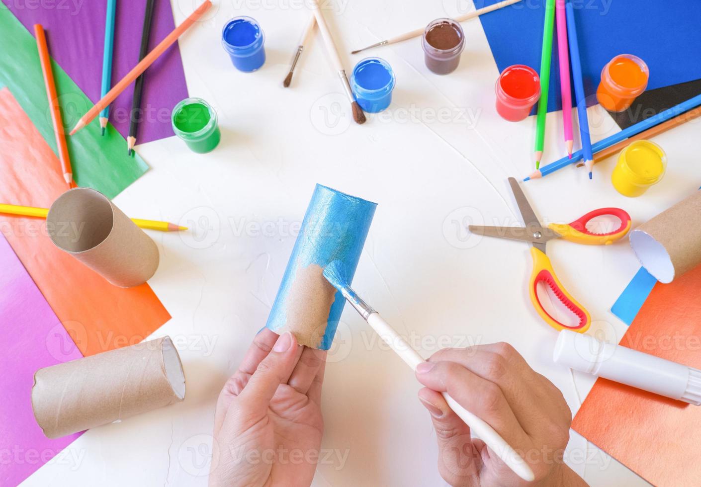 step 1. DIY paper rabbit from a roll of toilet paper. Easy craft for kids on white background, simple DIY idea from toilet tube, recycling concept. Gift ideas, decor for spring, Easter. photo