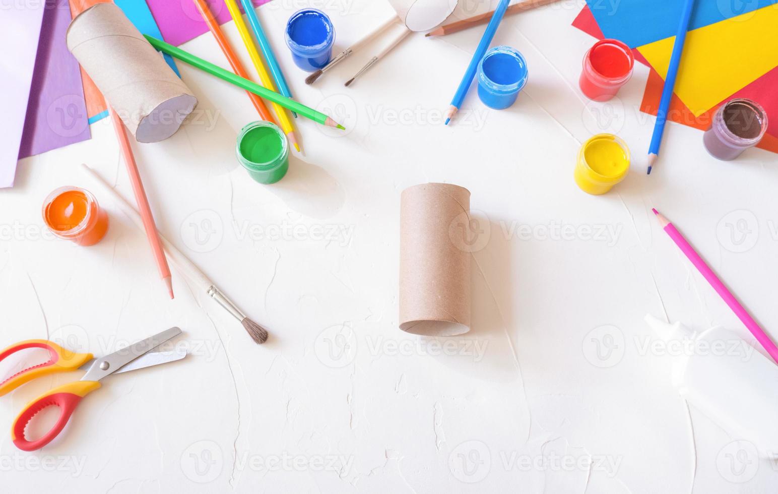 step 1. Holiday easy DIY craft idea for kids. Toilet paper roll tube toy chick baby on a white background with colored paper.. Creative Easter decoration eco-friendly photo