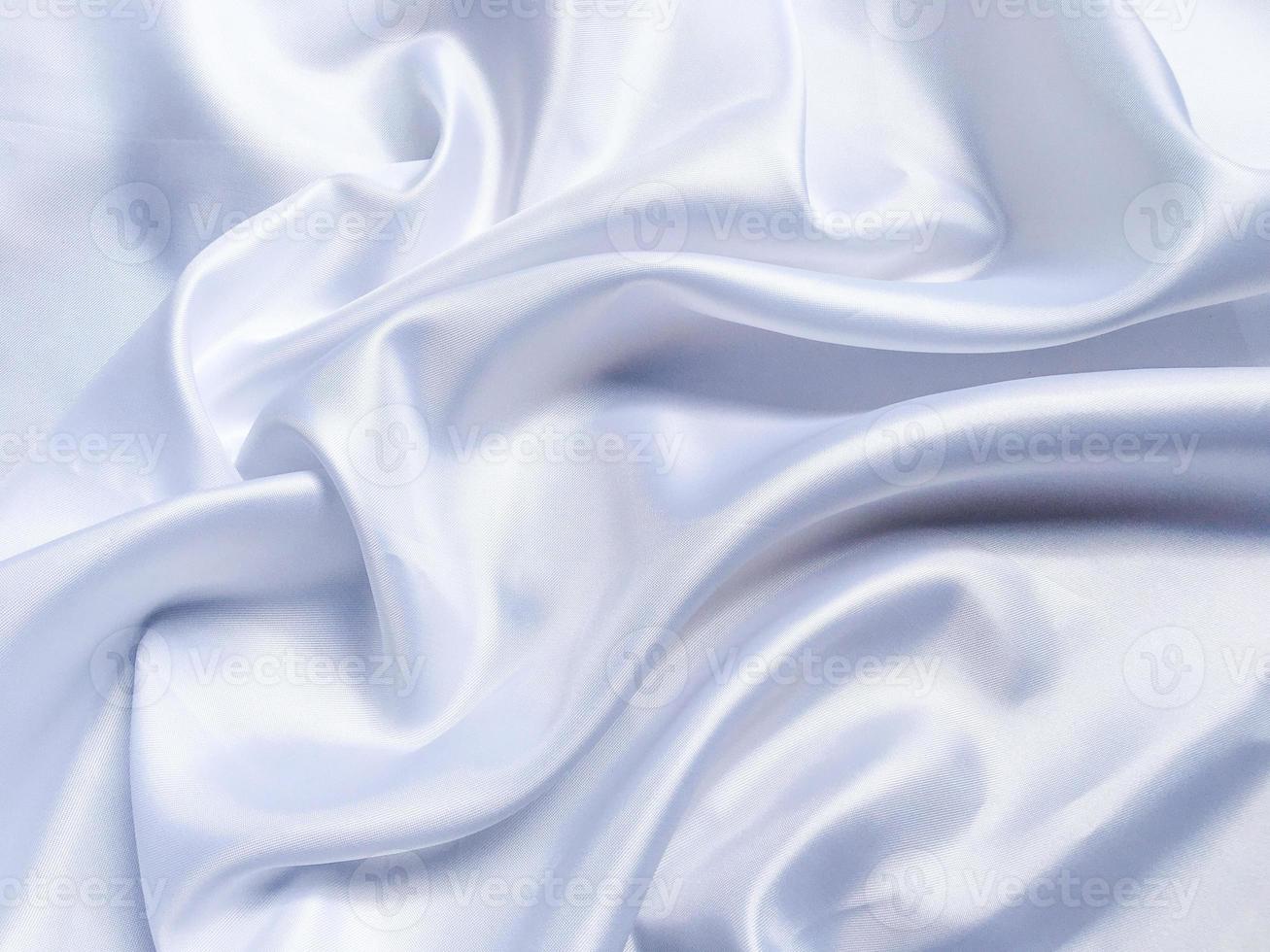 white crumpled fabric texture background. Silk curtain with fold waves for design photo