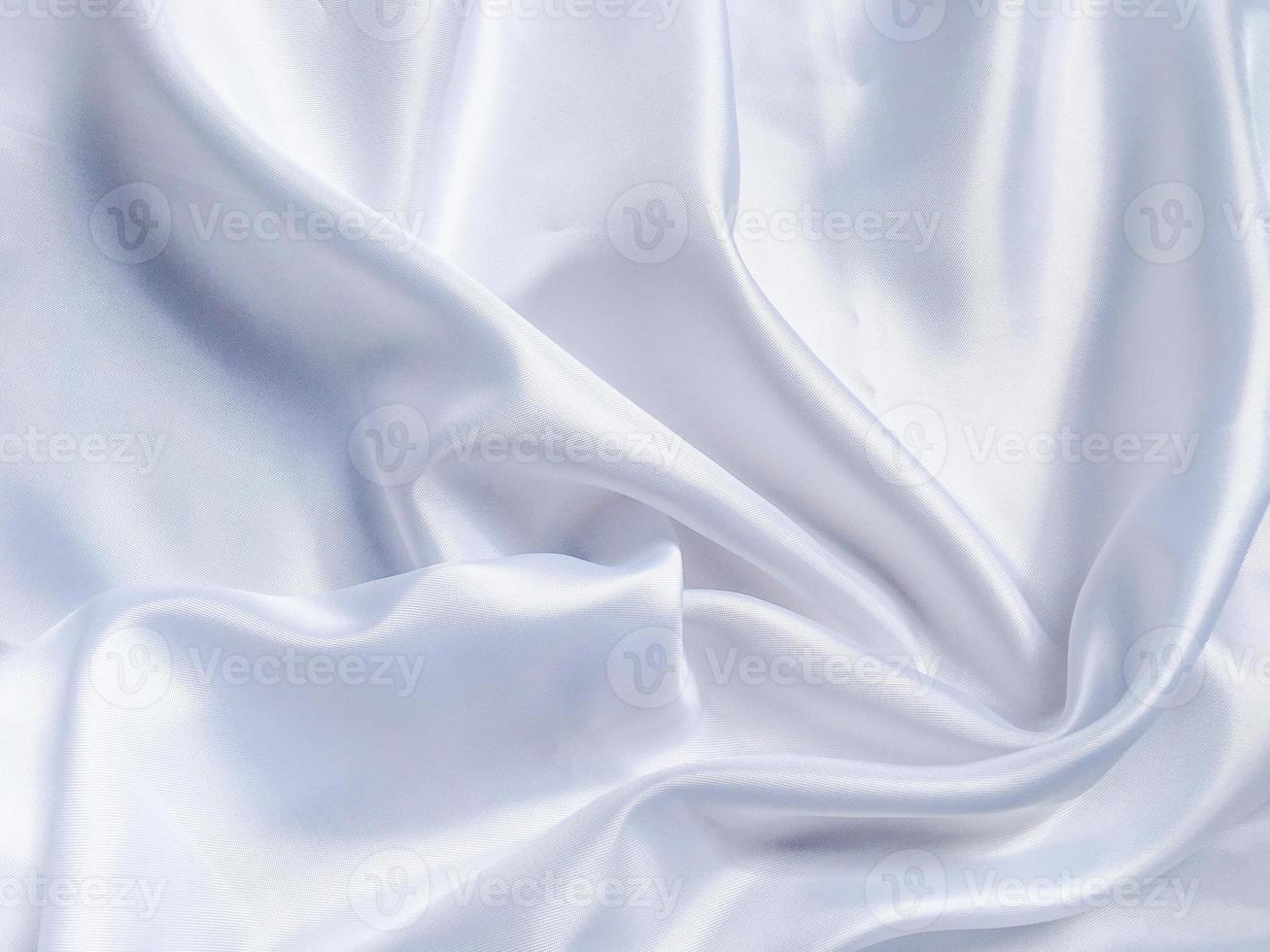 white crumpled fabric texture background. Silk curtain with fold waves