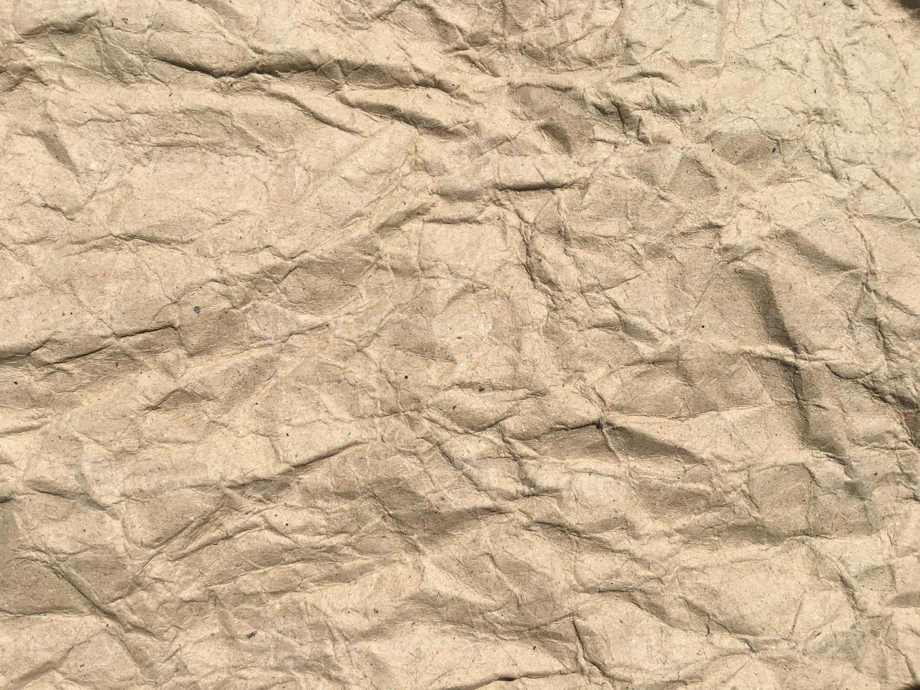 Brown crumpled paper background with copy space for Design. Wrinkled wallpaper Pattern photo