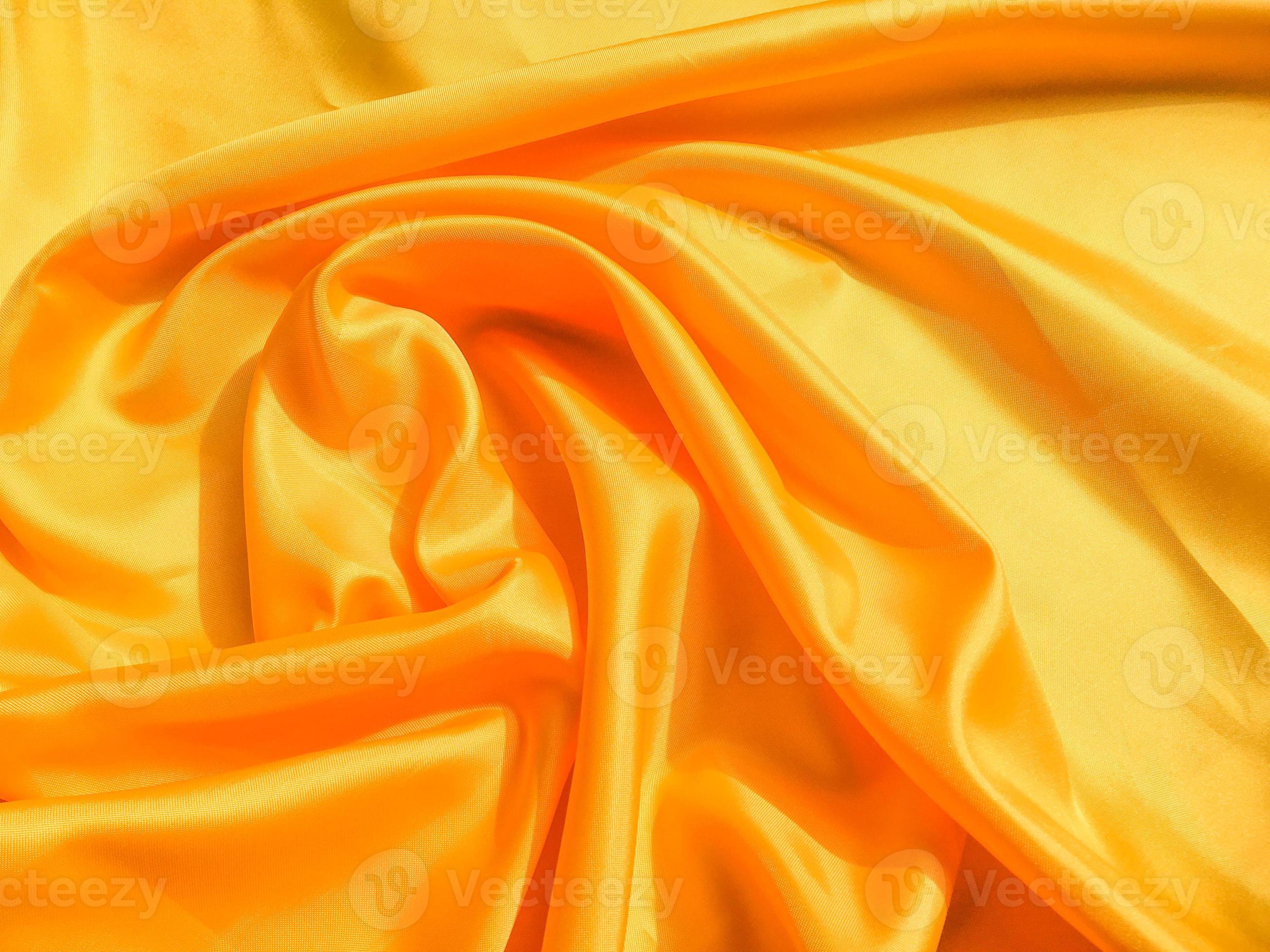 Yellow silk or satin texture background with copy space for design