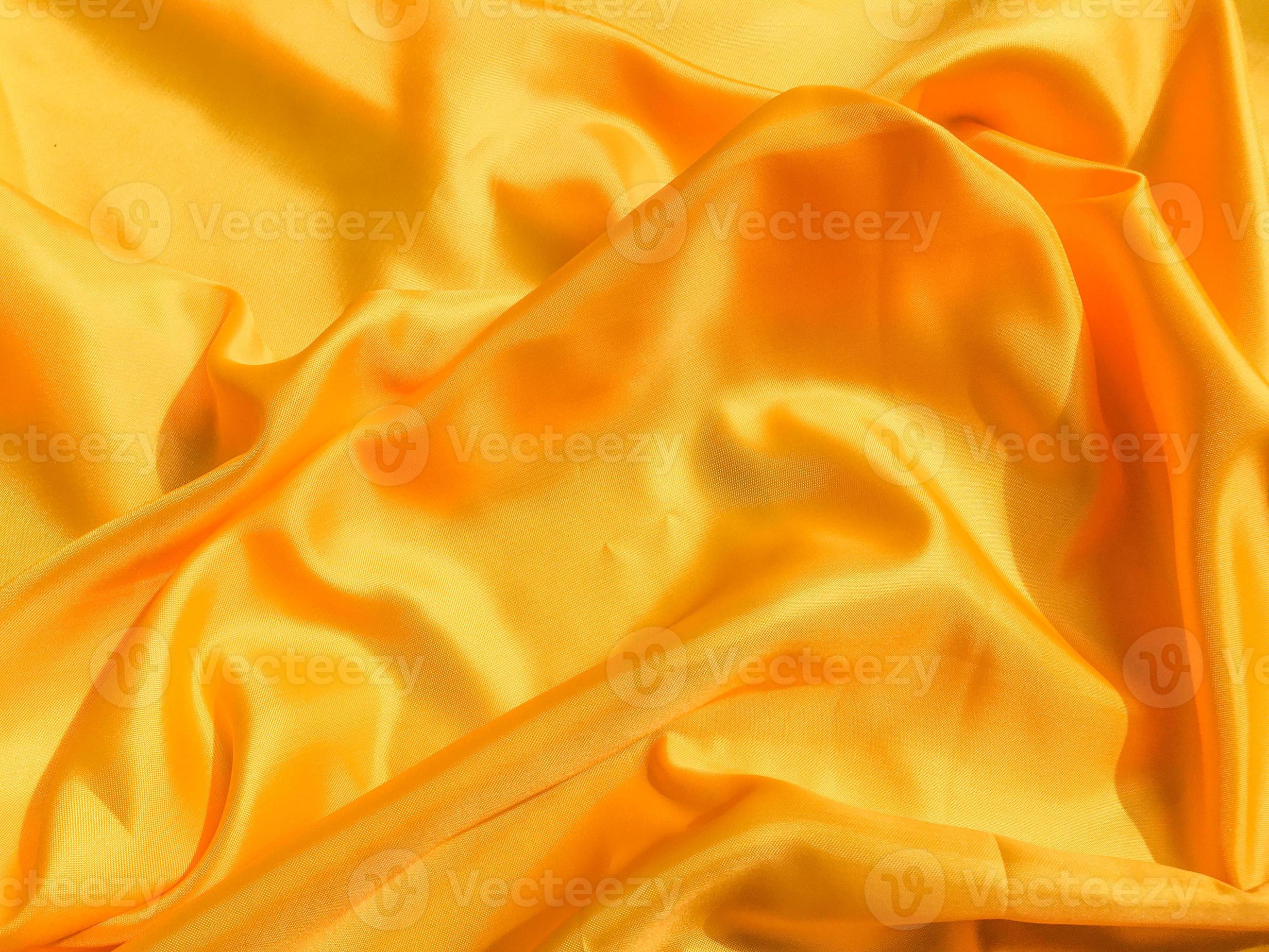Yellow silk or satin texture background with copy space for design