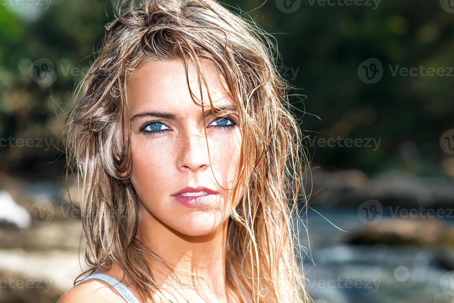 Portrait of beautiful blond girl with deep blue eyes with wet hair wildstyle photo