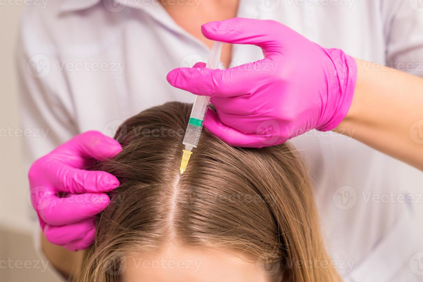 Woman receives injection in head photo