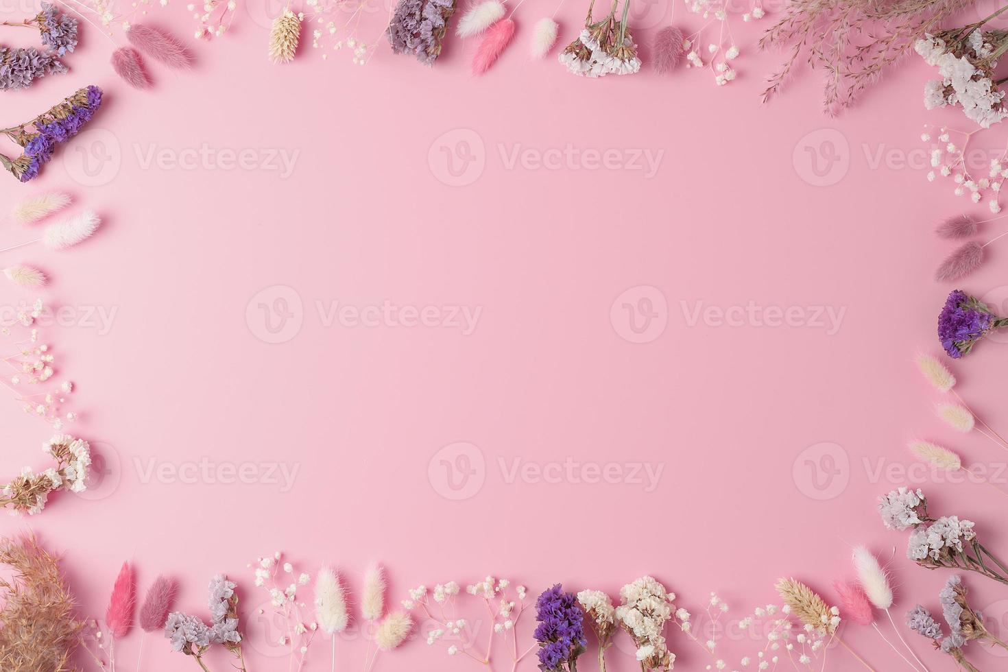Cosmetic background with flowers on pink. Flat lay, copy space photo