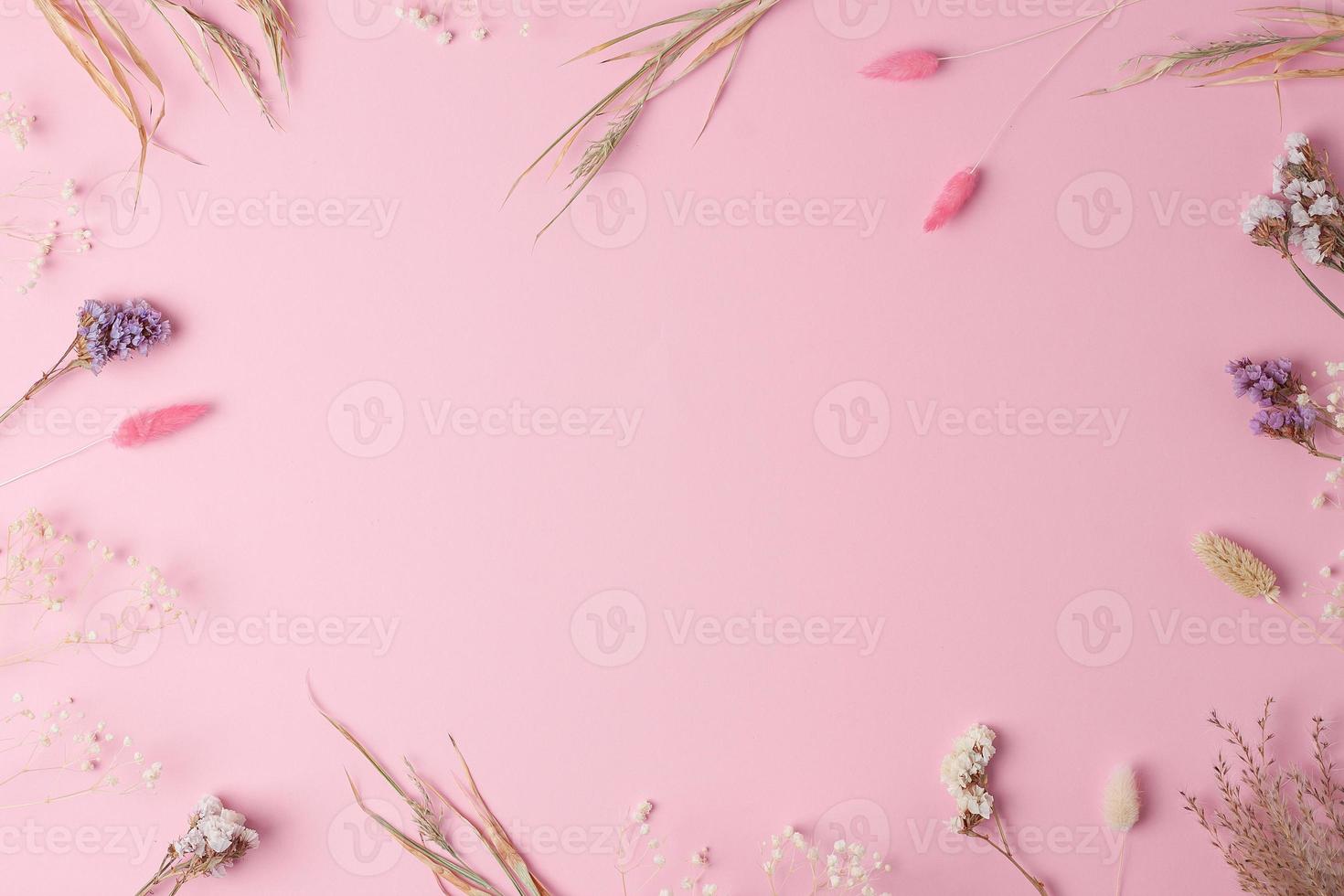 Cosmetic background with flowers on pink. Flat lay, copy space photo