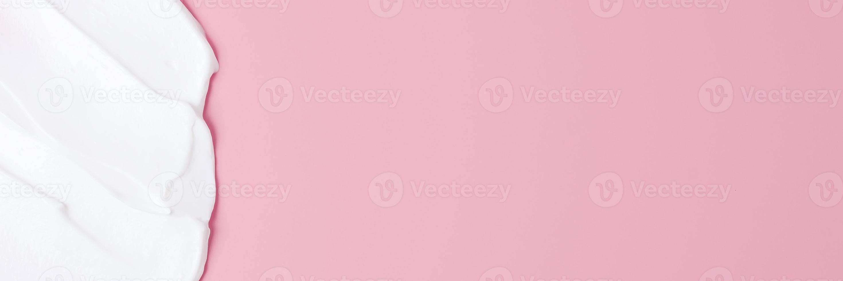 Cosmetic background with white cream on pink. Flat lay, copy space photo