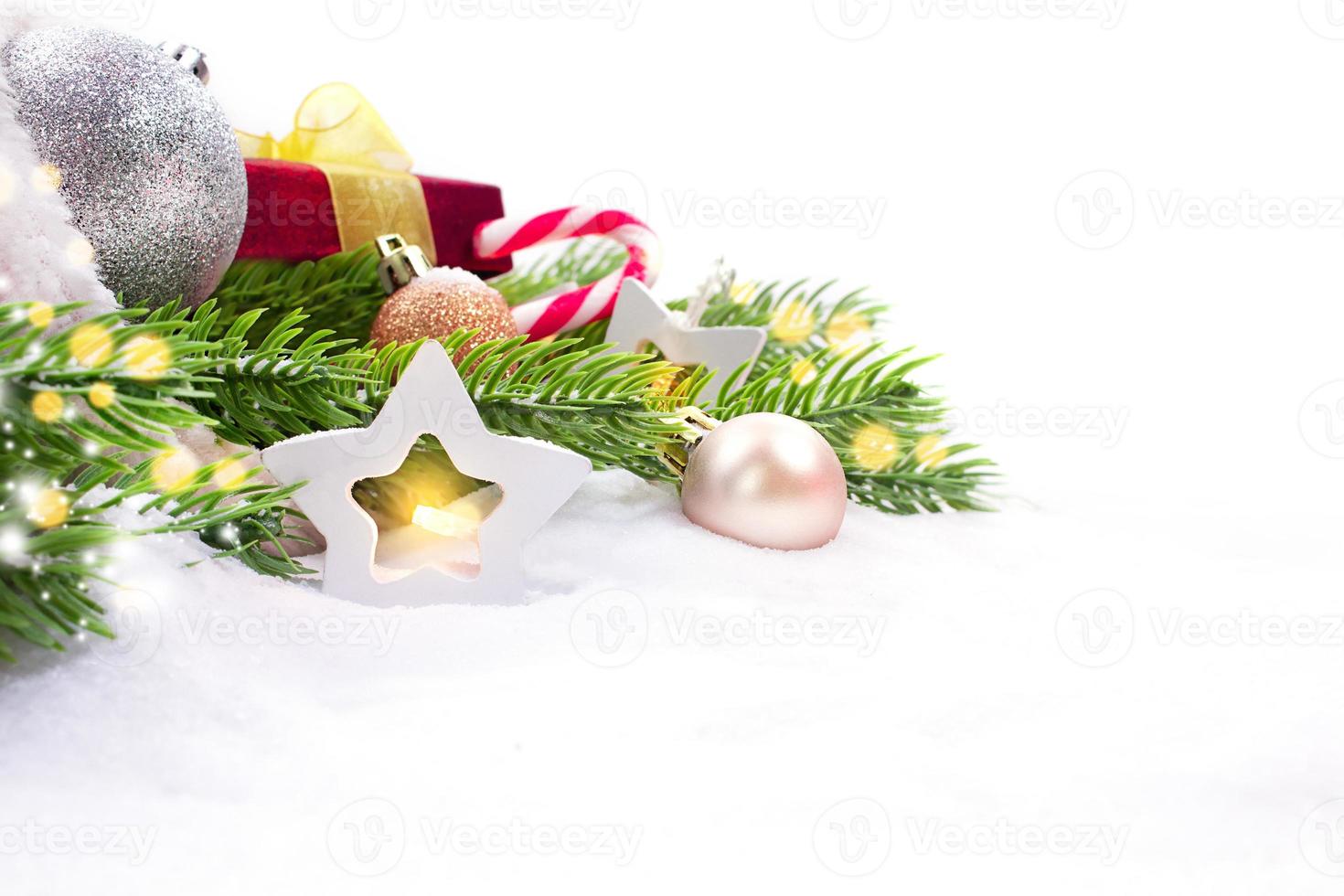 Bag with gifts and Christmas decorations balls, next to star light, fir branches on snow. New Year. Copy space photo