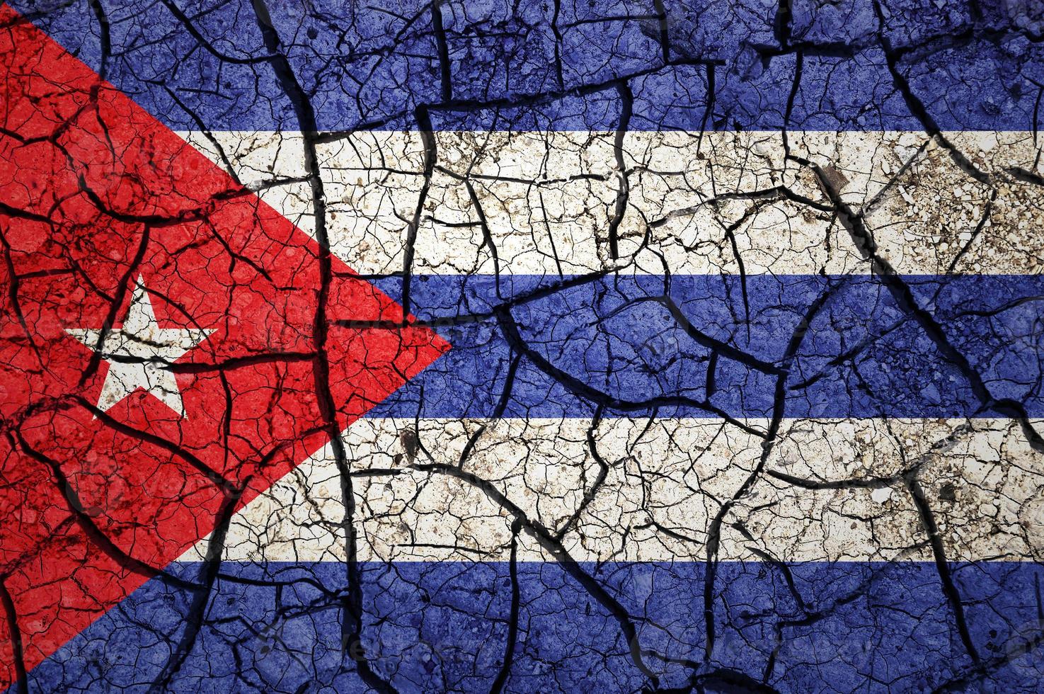 Dry soil pattern on the flag of Cuba. Country with drought concept. Water problem. Dry cracked earth country. photo