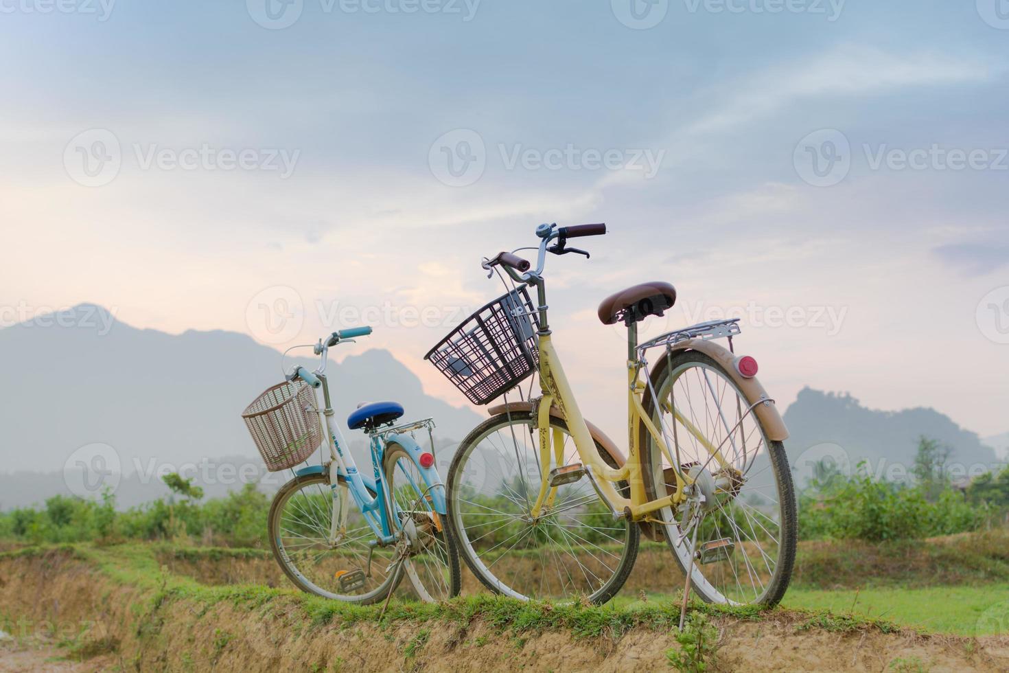 Two bicycles at sunset with mountain view at Vang Vieng photo