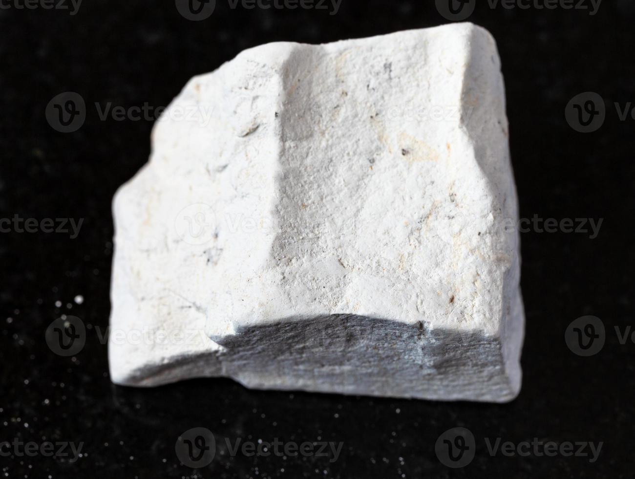 rough Chalk stone on black photo