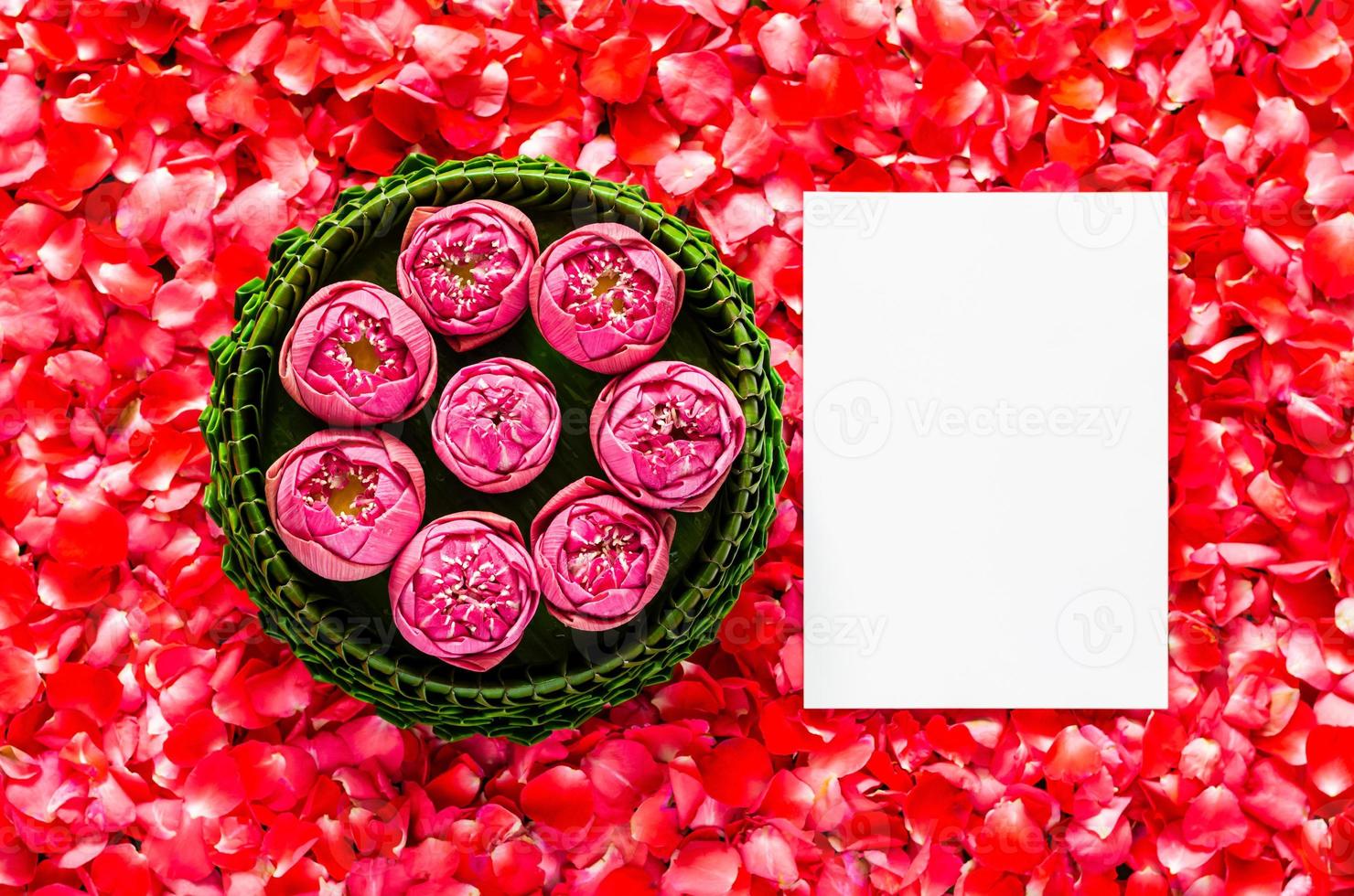 Banana leaf Krathong with lotus flowers for Thailand Full moon or Loy Krathong festival with space for text on red rose petals background. photo