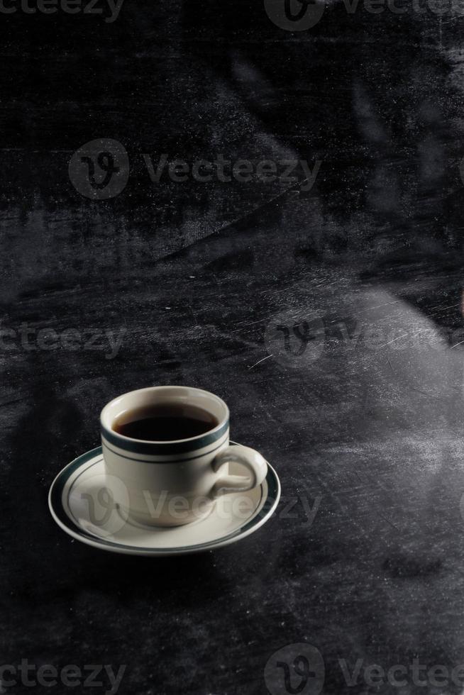 a cup of hot coffee on a black background. dark scene. banner space mock-up for adding text photo