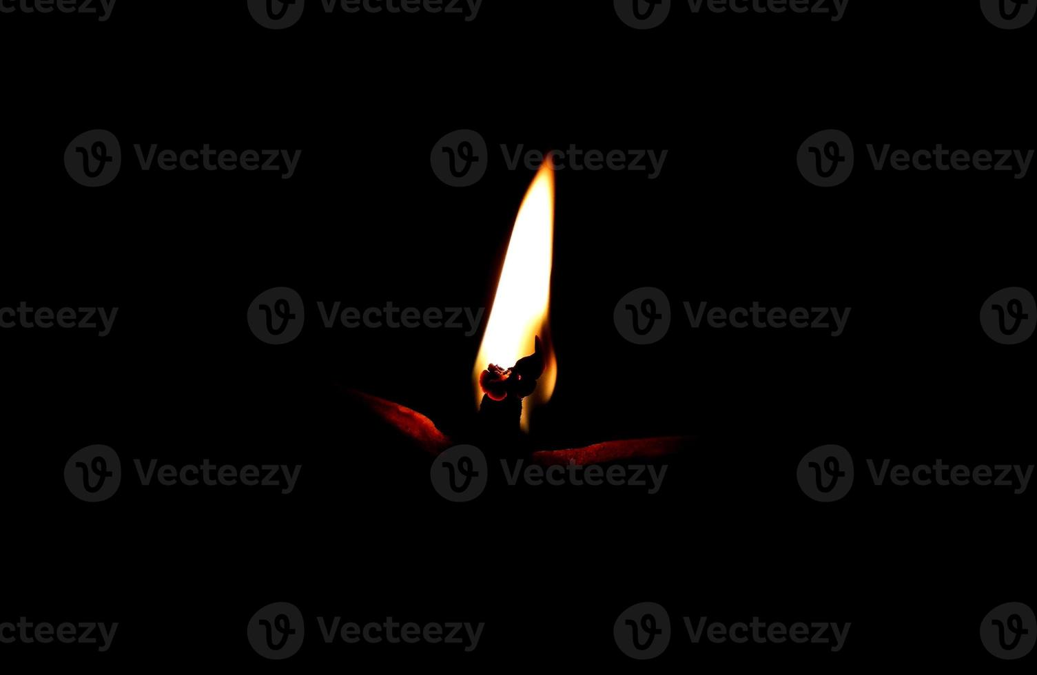 Soil or clay lamp radiating light in dark photo