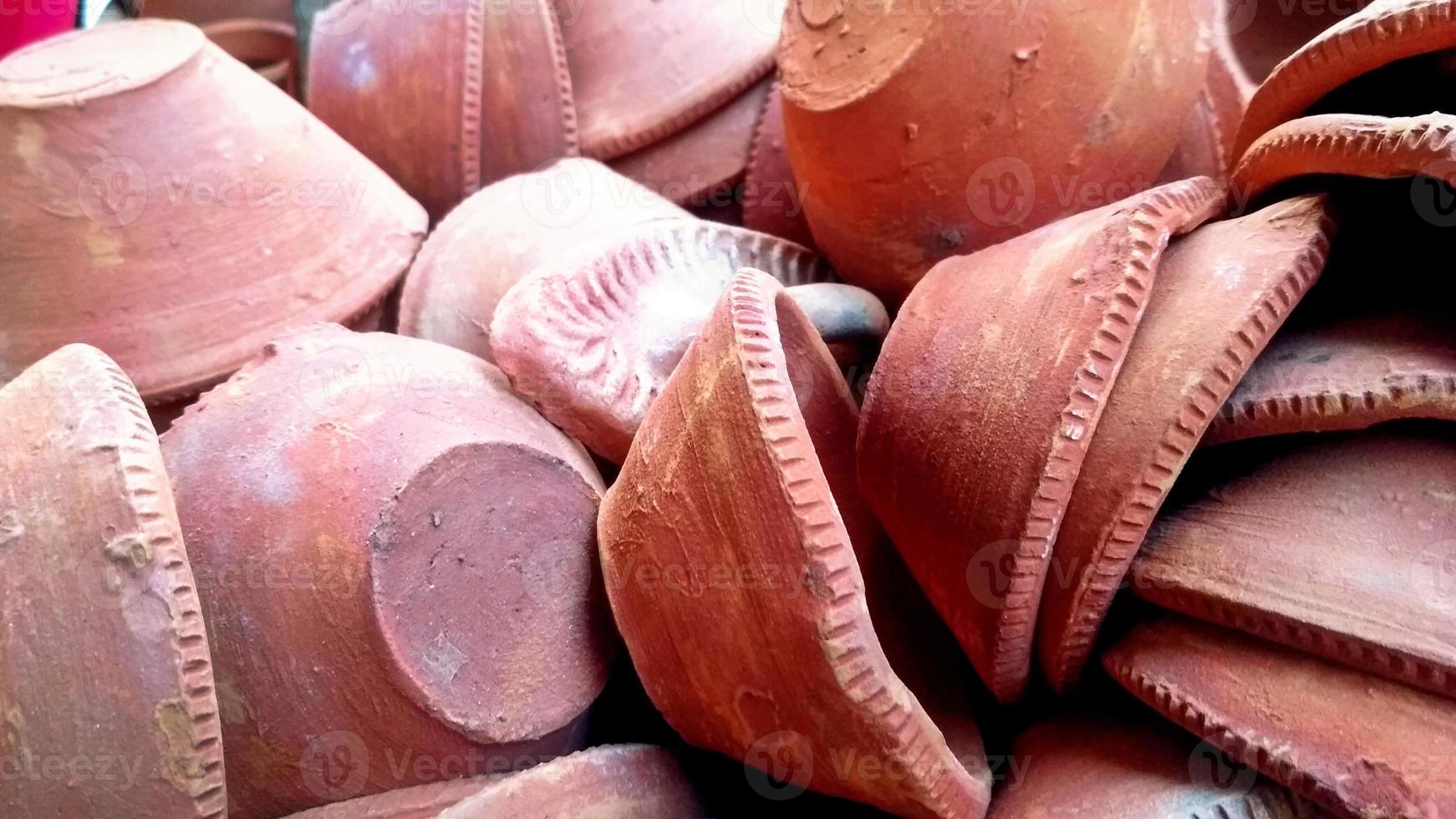 Close up of heap of Indian clay oil lanterns or diya ready to be sold in market during Diwali photo