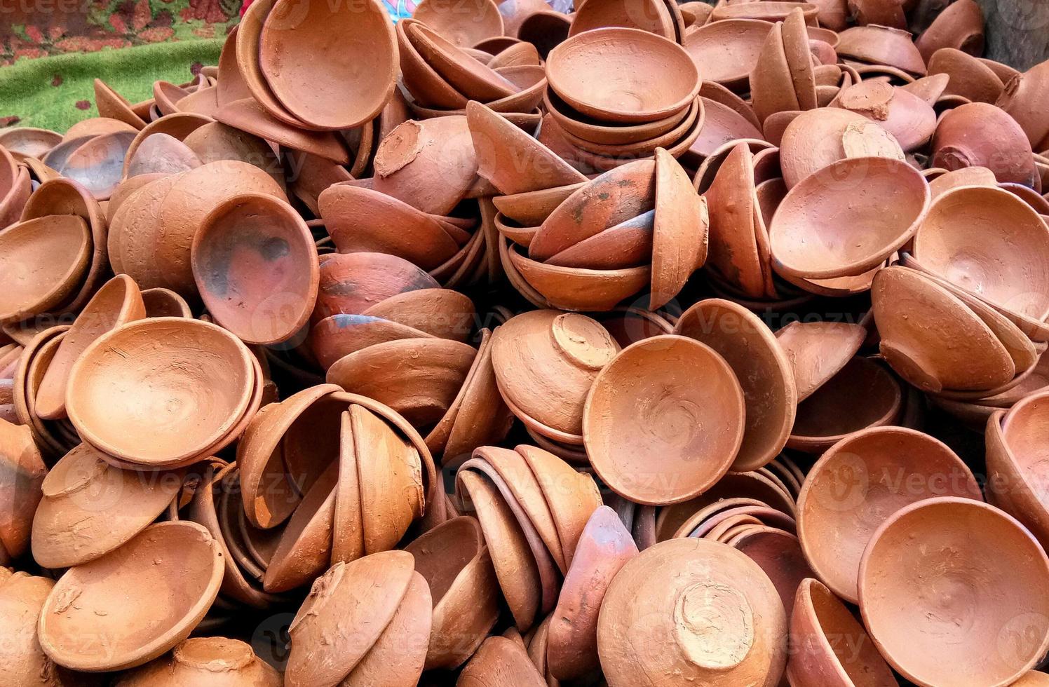 Close up of heap of Indian clay oil lanterns or diya ready to be sold in market during Diwali photo