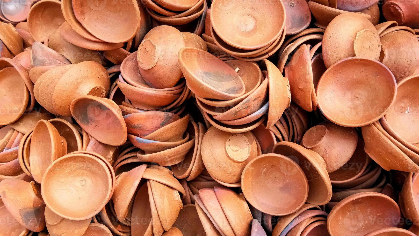 Close up of heap of Indian clay oil lanterns or diya ready to be sold in market during Diwali photo