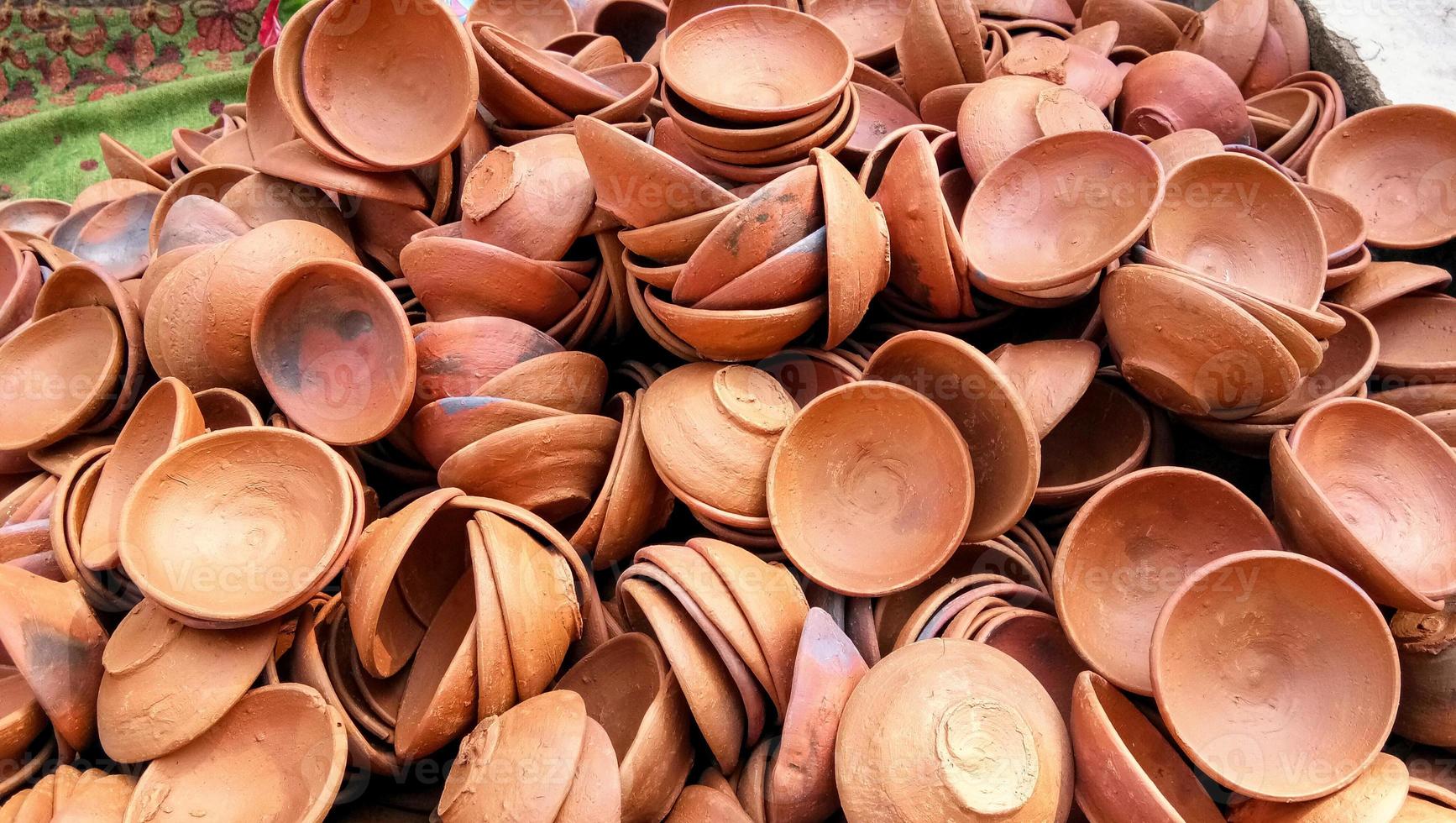 Close up of heap of Indian clay oil lanterns or diya ready to be sold in market during Diwali photo