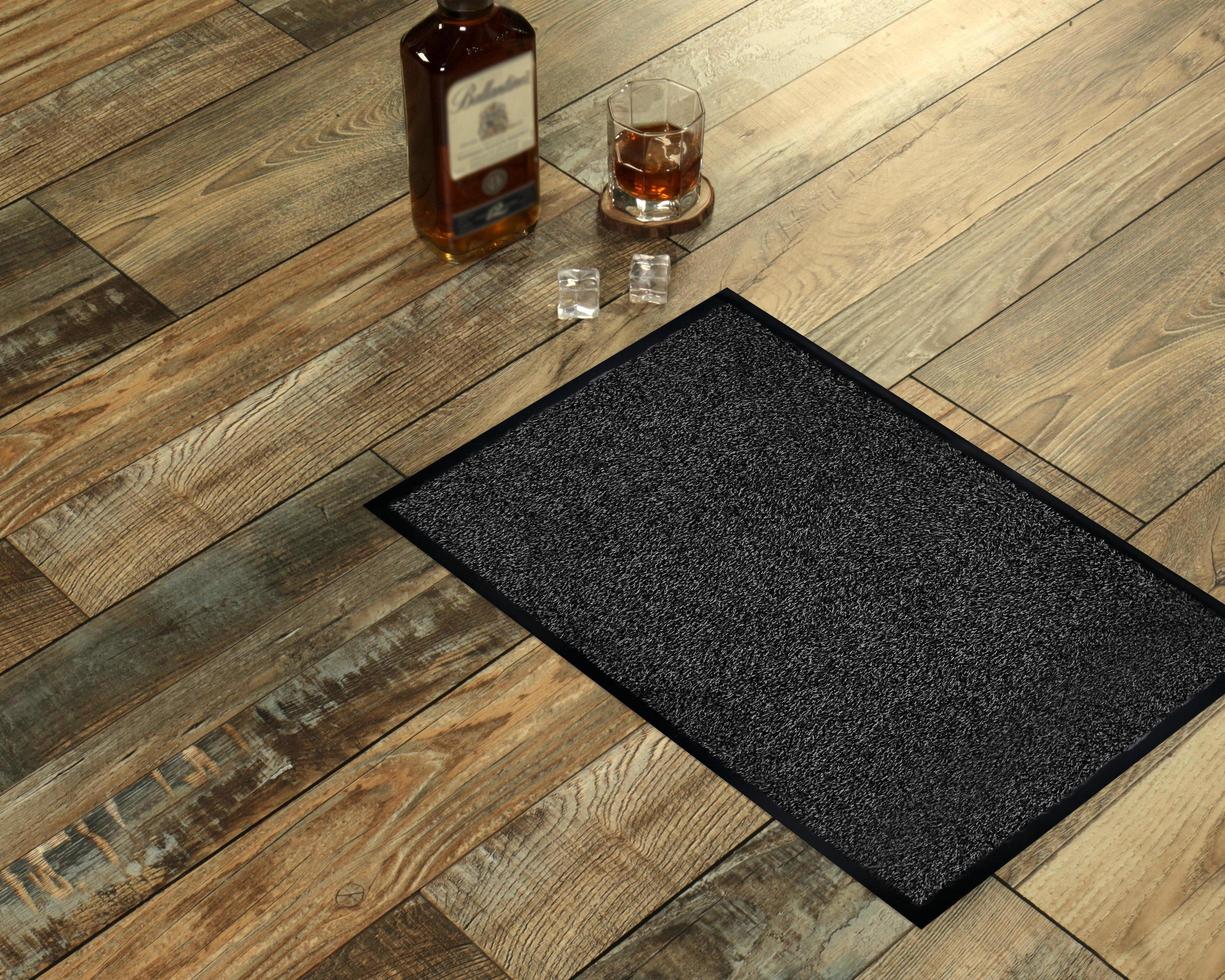 New Delhi, Delhi, IN, 2022 - Classic black grey welcome door mat with black border placed with Whiskey and Glass photo
