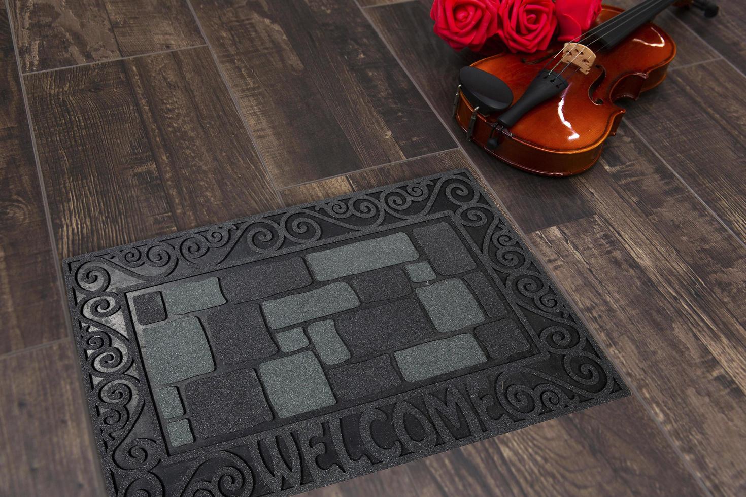 New Delhi, Delhi, IN, 2022 - Beautiful Black Grey Bobblestone Welcome Entry Rubber Glitter door mat placed on brown floor with Guitar photo