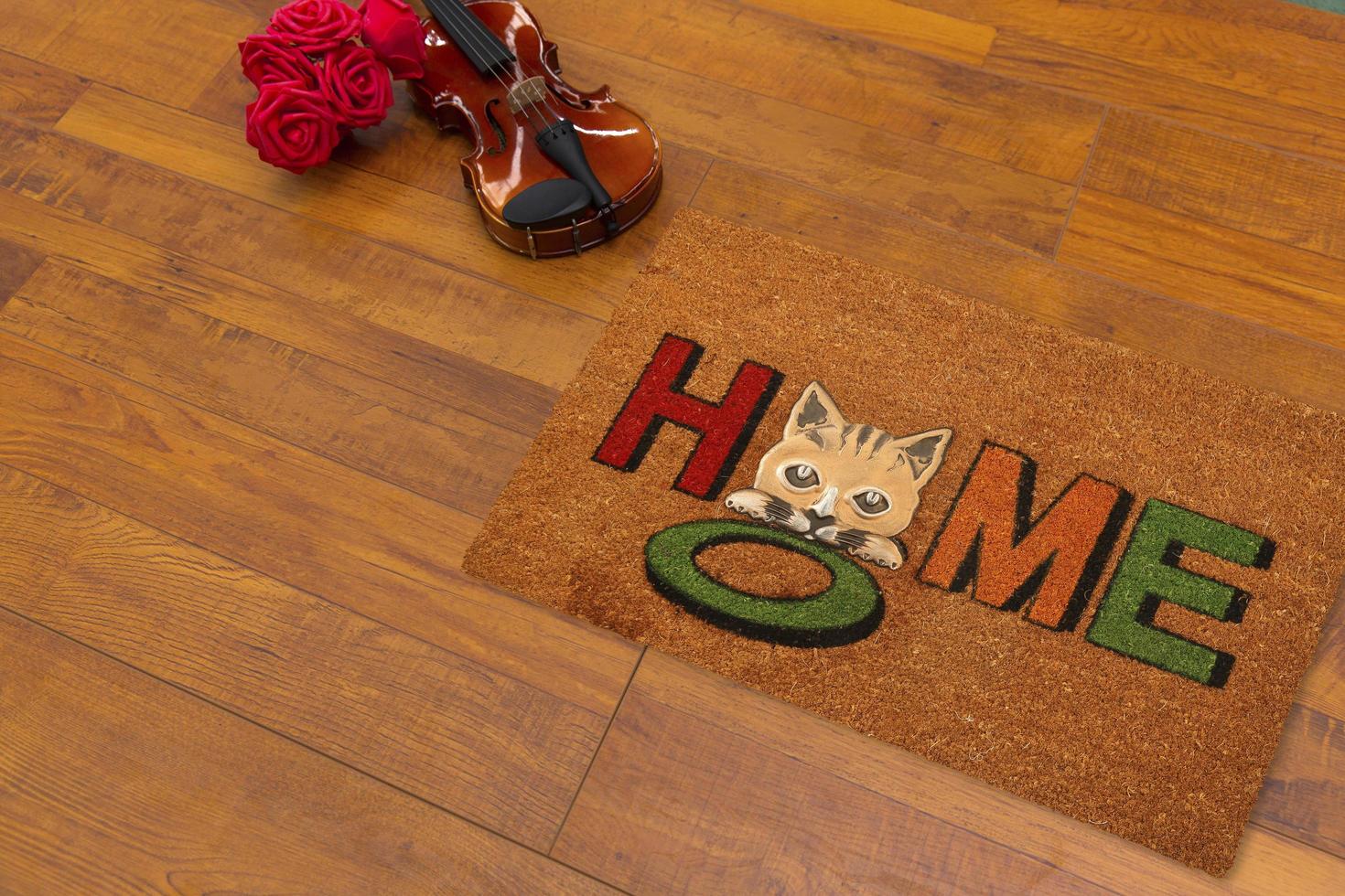 New Delhi, Delhi, IN, 2022 - Beautiful Colorful Little Hello Kitty Welcome zute doormat with HELLO placed on brown floor with Guitar photo