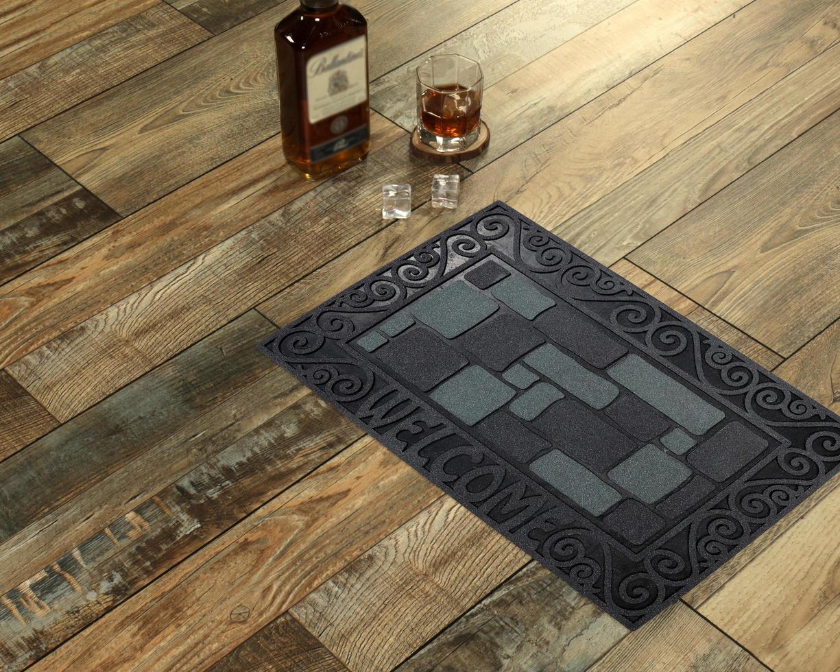 New Delhi, Delhi, IN, 2022 - Beautiful Black Grey Bobblestone Welcome Entry Rubber Glitter door mat placed with Whiskey and Glass photo